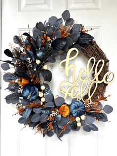 a wreath with the word hello fall painted on it