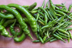 some green peppers are laying next to each other