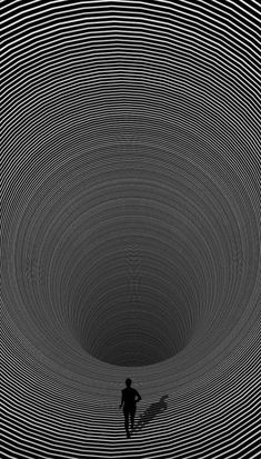 a person standing in the middle of a black and white tunnel with circles on it