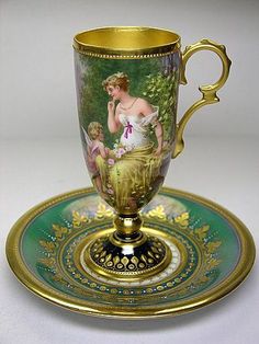 an antique cup and saucer on a plate