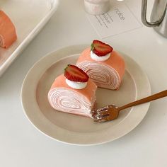 two slices of cake with strawberries on top