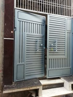 two blue doors are open in front of a building