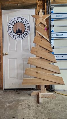 a small wooden christmas tree sitting in front of a door