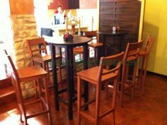 a table and chairs in a room with yellow walls, wood floors and tile flooring