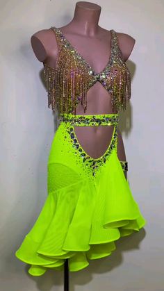 neon green latin dance dress with sequins and beads on the bust, in front of a mannequin