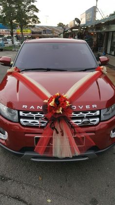 a red car with a bow tied to it