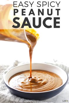 the sauce is being drizzled over in a white bowl with text reading easy spicy peanut sauce