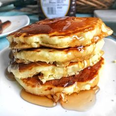 three pancakes stacked on top of each other covered in syrup