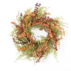 an orange and red berry wreath on a white background