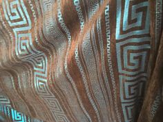 a close up view of a brown and blue patterned material with white lines on it