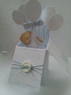 a baby's congratulations card with balloons and a teddy bear in the top box