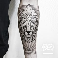 a man's arm with a tattoo on it and a lion head in the middle