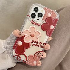 a person holding a phone case with cartoon characters on it