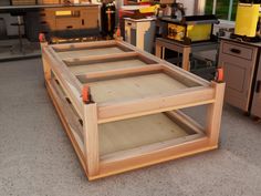 a wooden shelf sitting in the middle of a room filled with cabinets and other items