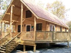 a wooden cabin with stairs leading up to it