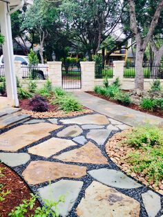 a stone walkway in front of a house