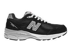 the new balance 997 running shoe is black and white with silver trimmings