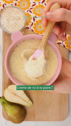 a person holding a wooden spoon over a bowl of oatmeal and pears