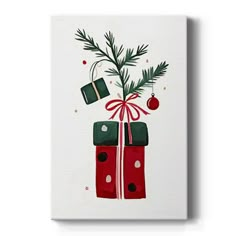 a christmas present wrapped in red and green wrapping paper with a pine branch sticking out of it