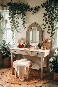 a desk with a mirror, stool and plants on the wall in a room filled with potted plants