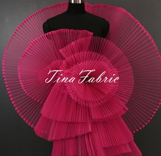 a dress made out of pleated material with the word tina fabric on it