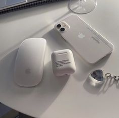 an apple product is sitting on a table next to other electronics and gadgets