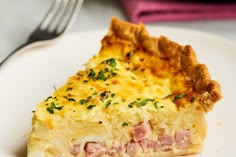 a piece of ham and cheese quiche on a white plate