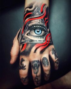 a person's hand with tattoos on it and an all seeing eye tattooed on the palm