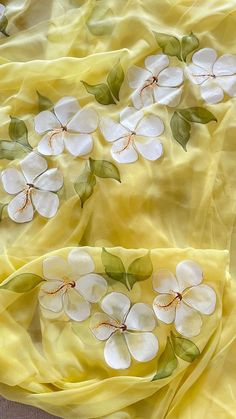 the yellow fabric has white flowers on it