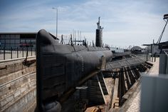 a submarine sitting on top of a wooden dock