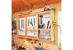 a workbench with tools hanging on the wall