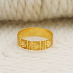 a gold ring sitting on top of a white blanket