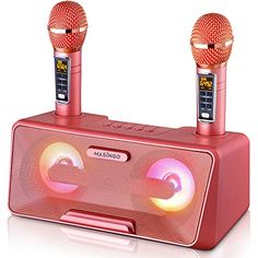 two red microphones sitting next to each other on top of a radio receiver with an alarm clock