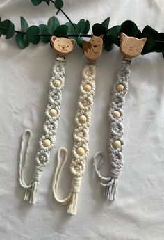 three crocheted bracelets with wooden birds on them sitting next to each other