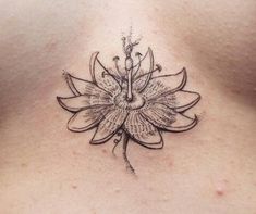 a woman's chest with a flower tattoo on it