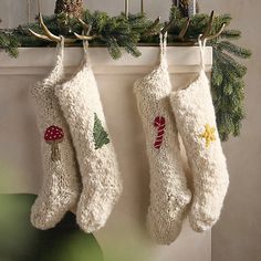 two christmas stockings hanging from a mantel