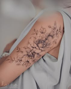 a woman with a flower tattoo on her arm