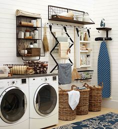 an image of a laundry room with clothes hanging on the wall and other items in baskets