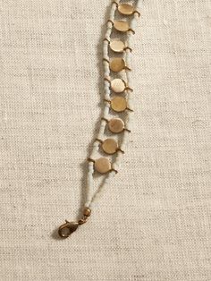 Saw this on Banana Republic: Brass Beaded Bracelets With Round Beads, Adjustable Brass Jewelry With Round Beads, Artisan Brass Jewelry With Tiny Beads, Adjustable Brass Beaded Chain Jewelry, Hand-strung Cream Bohemian Jewelry, Jewelry Shapes, Boho Jewelry Bracelet, Tube Bead Bracelet, Tiny Bead Bracelet