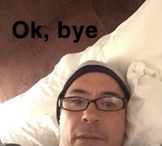 a man laying in bed wearing glasses and a headband