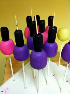 there are many different colored cake pops on the table