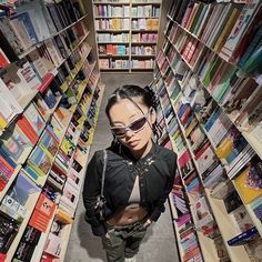 a woman standing in the middle of a book store