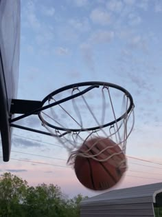 a basketball going through the rim of a hoop