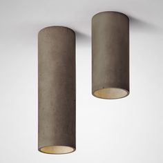 two concrete lamps hanging from the ceiling