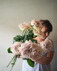 a woman holding a bouquet of flowers in front of her face