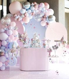 there is a pink and white party with balloons on the wall, stars in the background