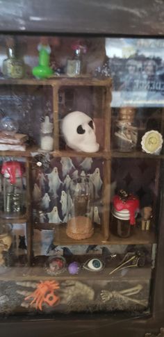 a display case filled with lots of different types of items and decorations on top of wooden shelves