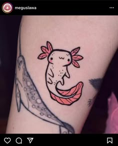 a woman's arm with a tattoo on it that has an image of a fish