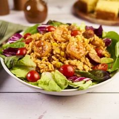 a white bowl filled with salad on top of a table