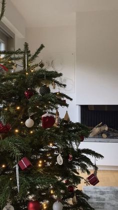 a small christmas tree with red and white ornaments